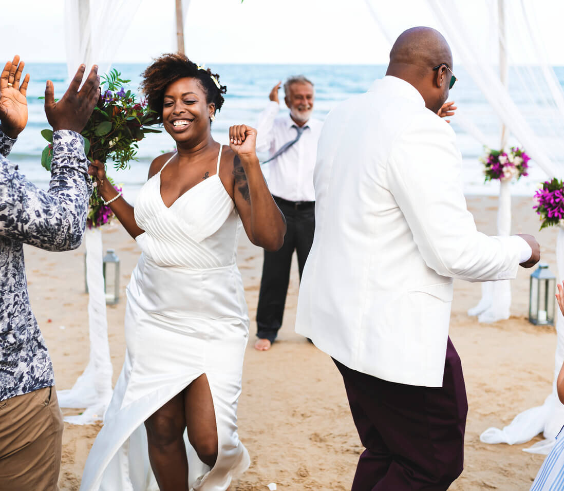 bride and groom having fun first dance on beach .jpg