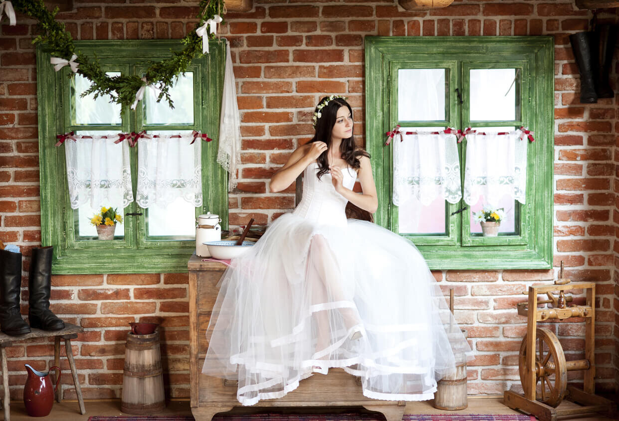 bride sitting outside in sleeveless rustic wedding dress.jpg
