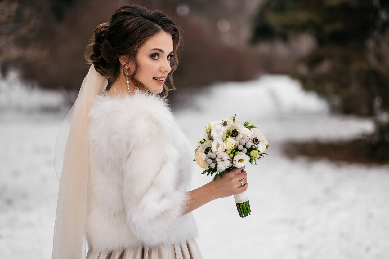 https://www.wedding-spot.com/blog/sites/wsblog/files/images/migrated/203-bride%2Bwearing%2Bfur%2Bwrap%2Bcarrying%2Bbouquet.jpg