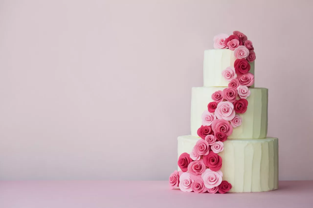 Tiered wedding cake with sugarpaste roses in pink