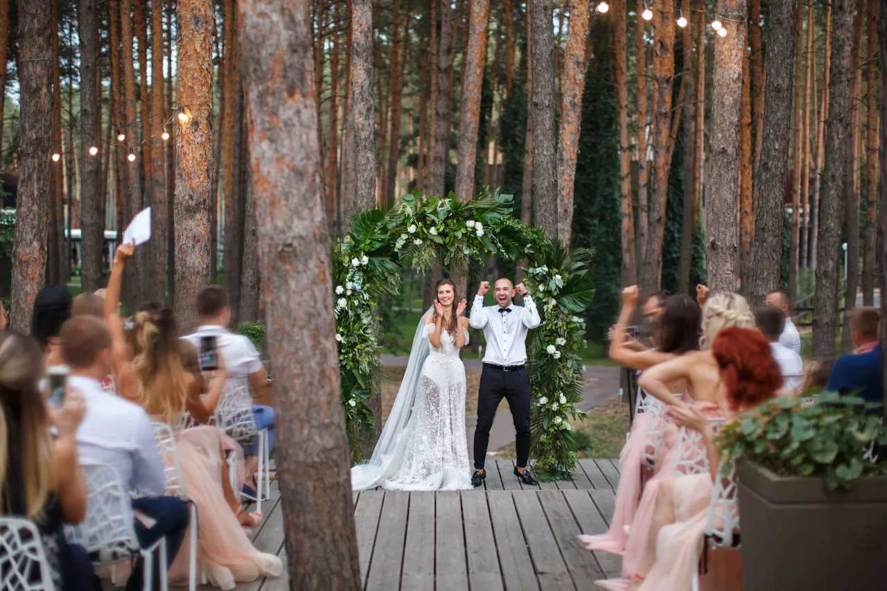 couple celebrating their marriage in a forest