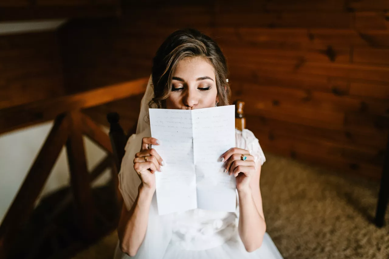 bride reading wedding vows for her