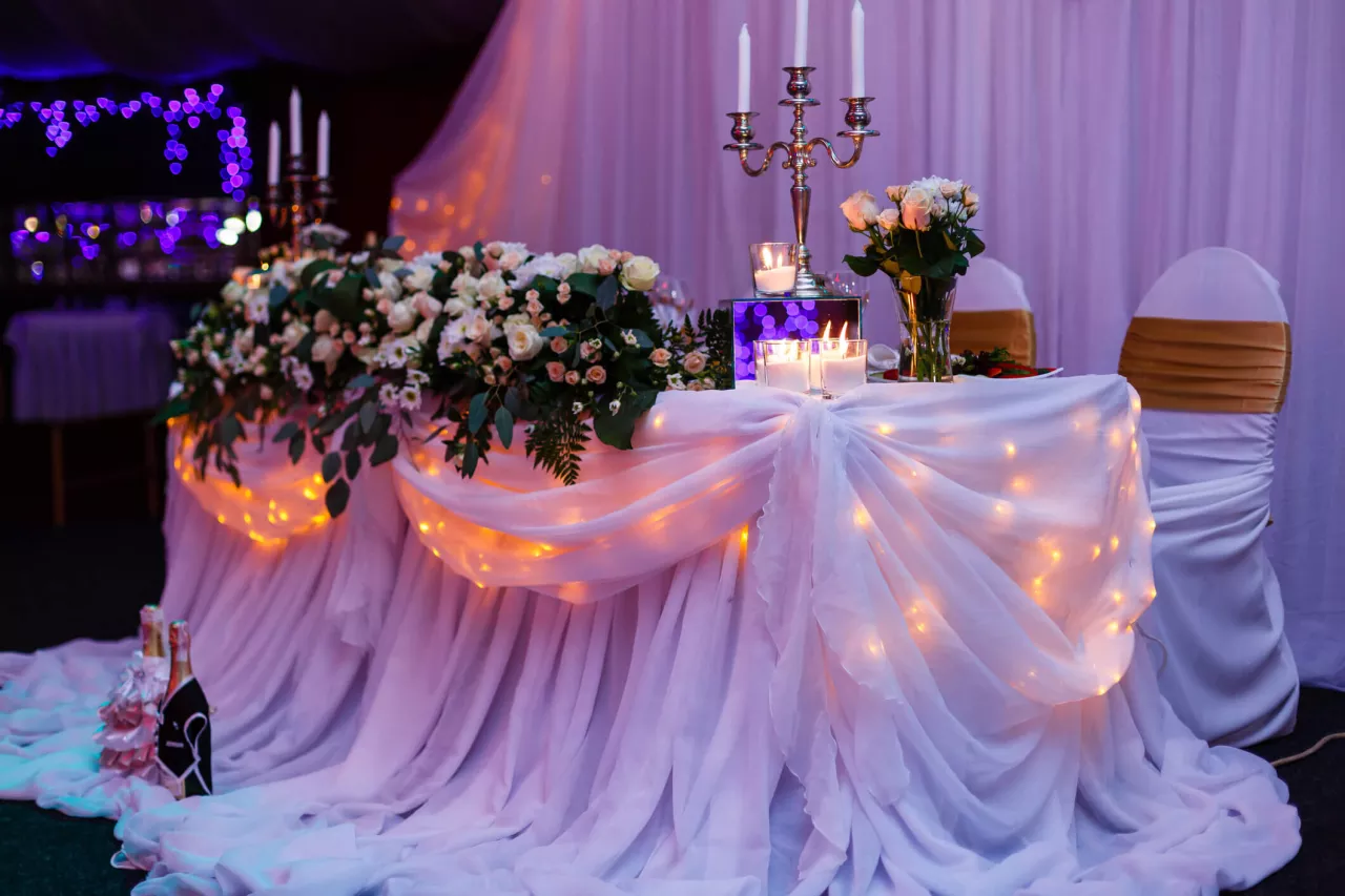 wedding sweetheart table with flowers and candles