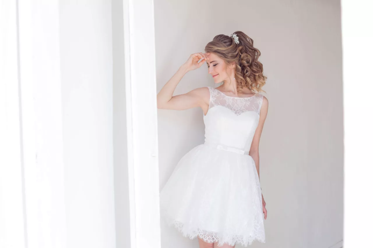 bride smiling in short wedding dress with lace and tulle