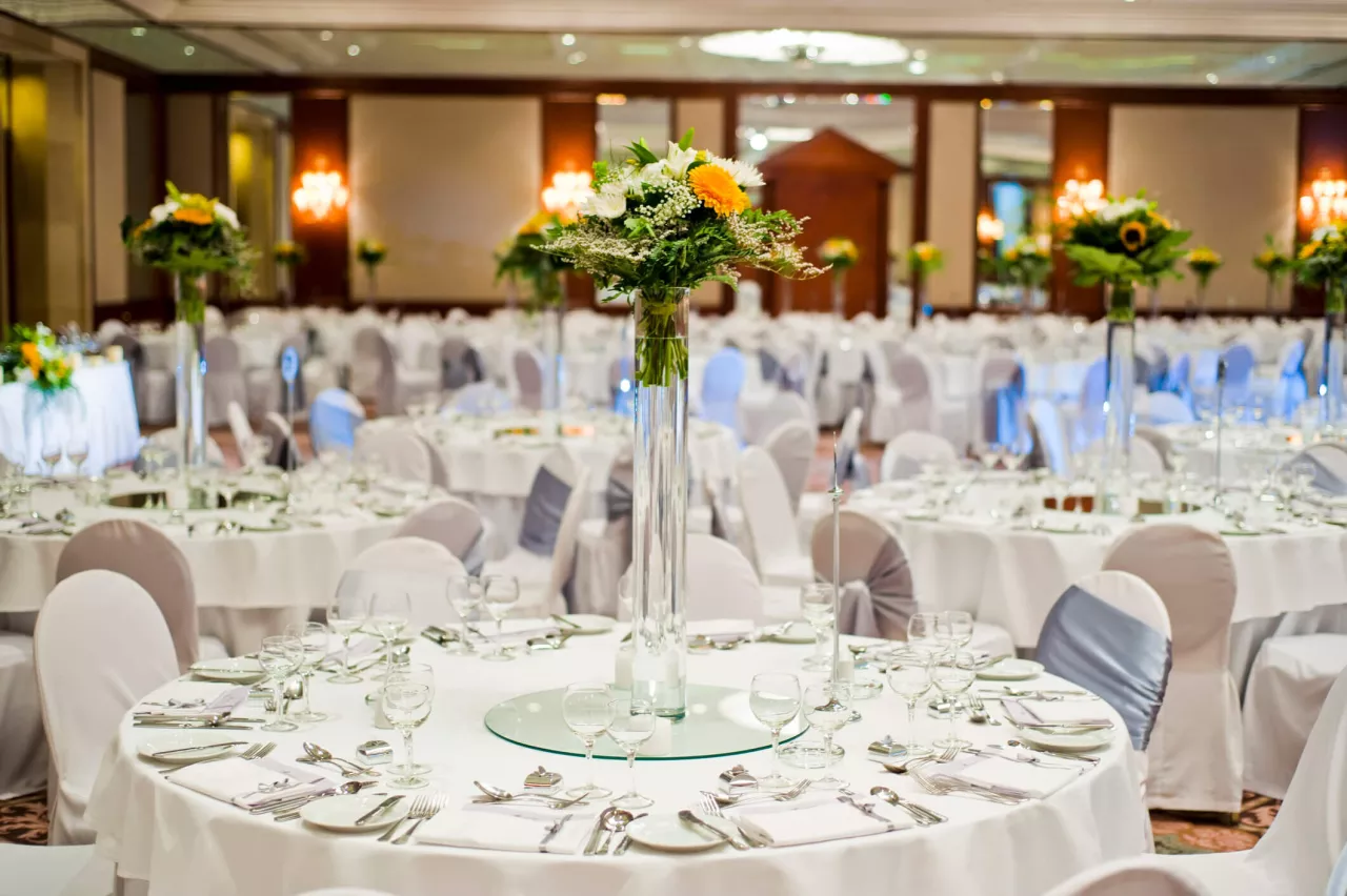 beautiful wedding hall with white tablecloths and flower centerpieces