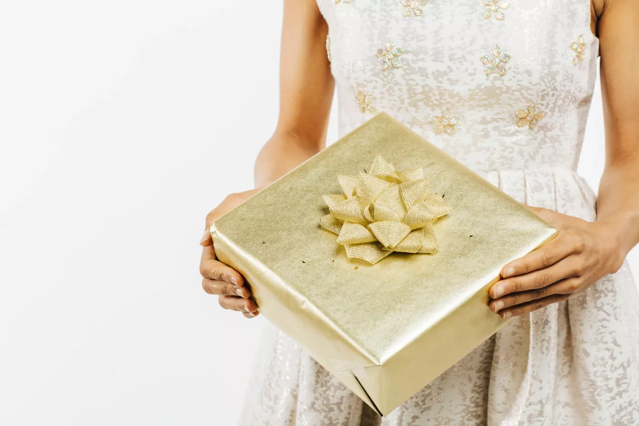 Woman holding gold wedding gift