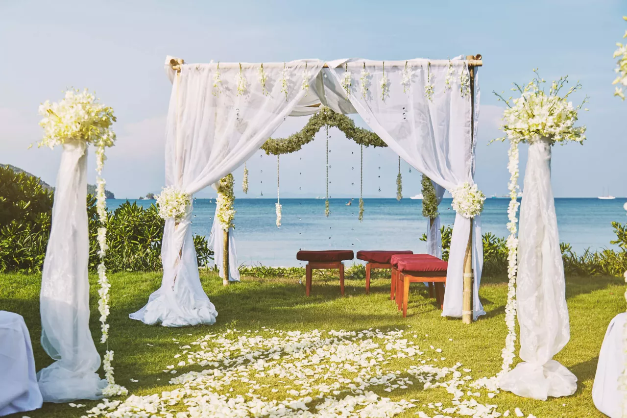 wedding arch with flowers overlooking ocean