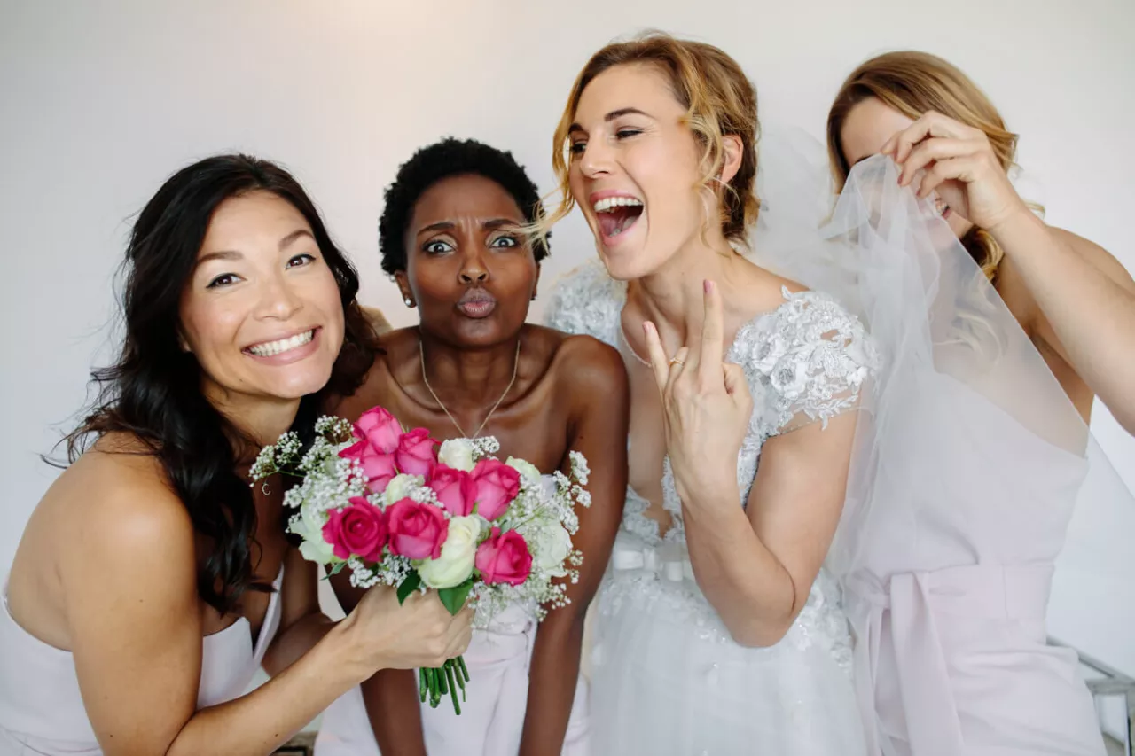 members of bridal party smiling with bride