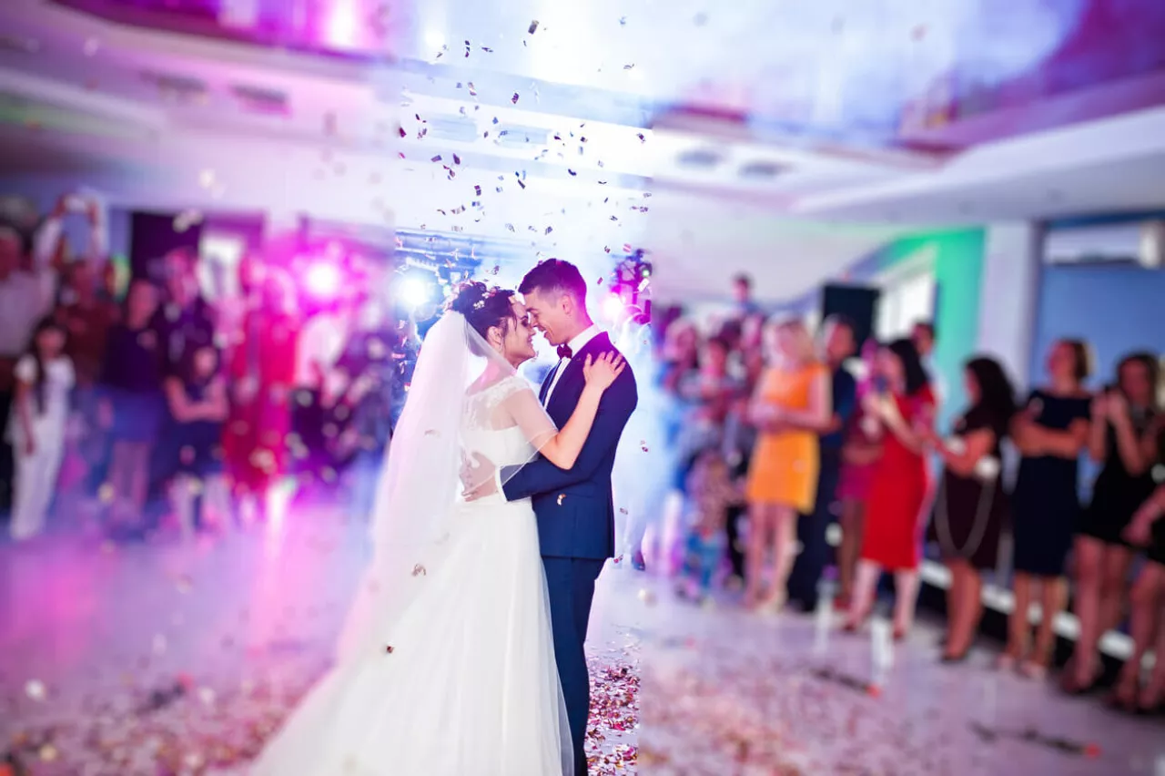 bride and groom embracing to first dance song at wedding