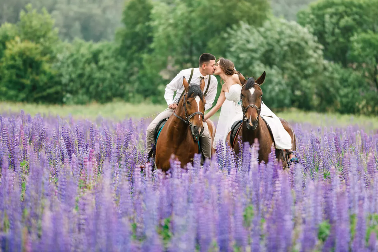 bride and groom exiting wedding on horseback