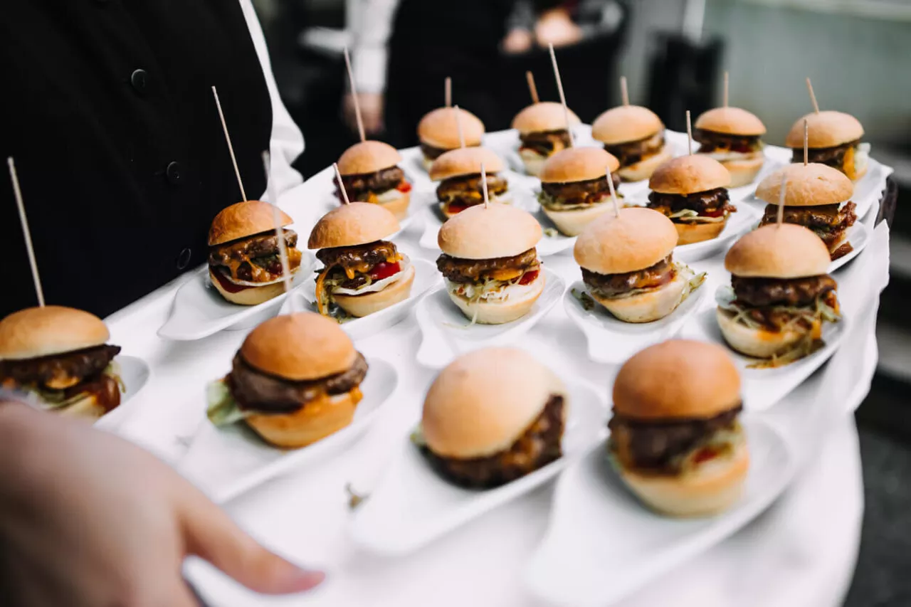 small burgers being served as wedding midnight snack