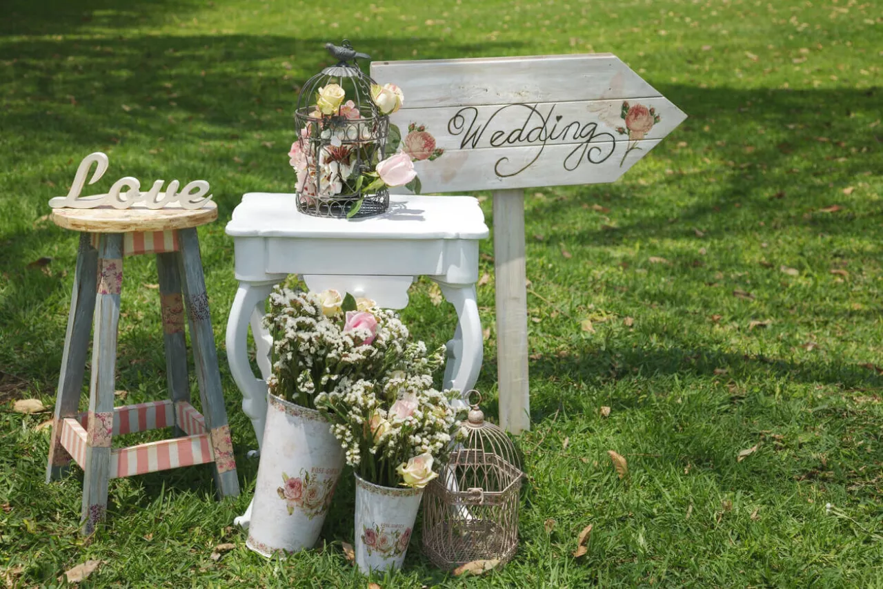 wooden welcome sign and flowers for outdoor picnic wedding