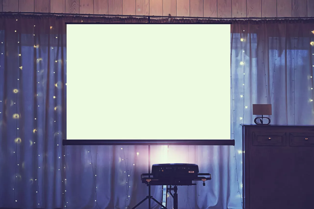 projector and screen set up at wedding for slideshow