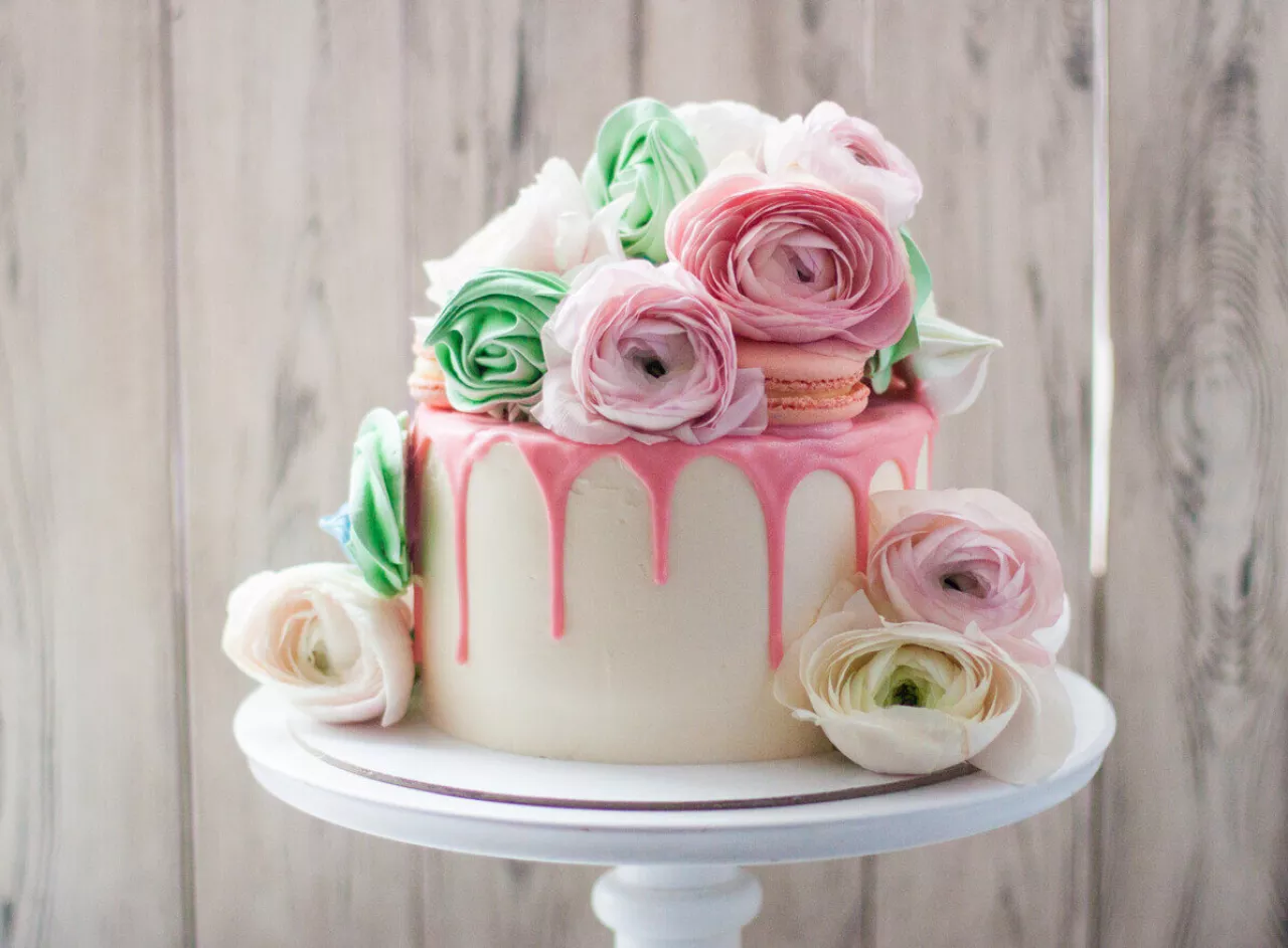 wedding cake with pink melted chocolate meringue fresh flowers