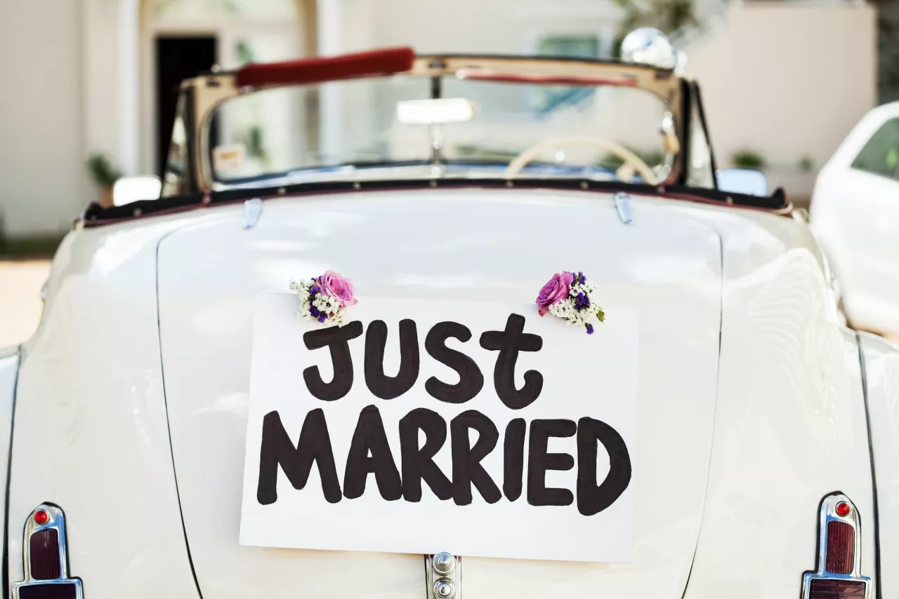 old white car with just married sign