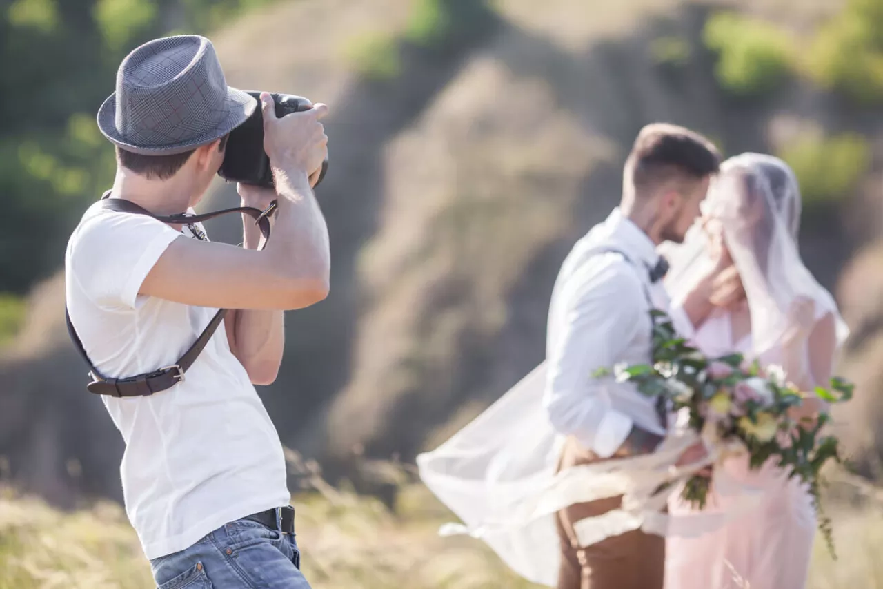 wedding photographer taking pictures of bride and groom