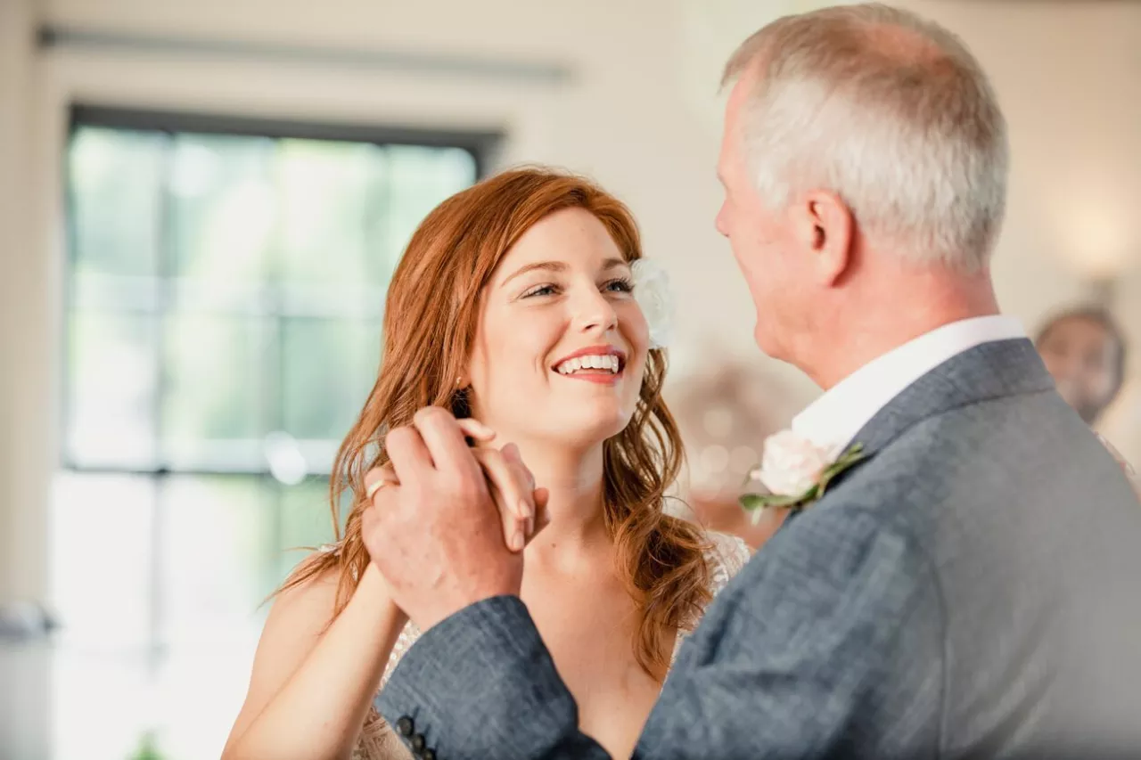 bride and her dad smiling at each other during father-daughter dance