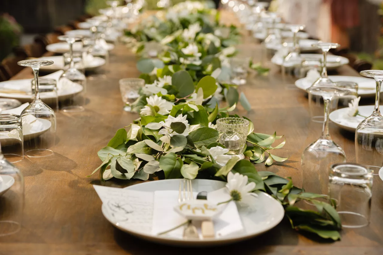 plates and flowers on wedding table