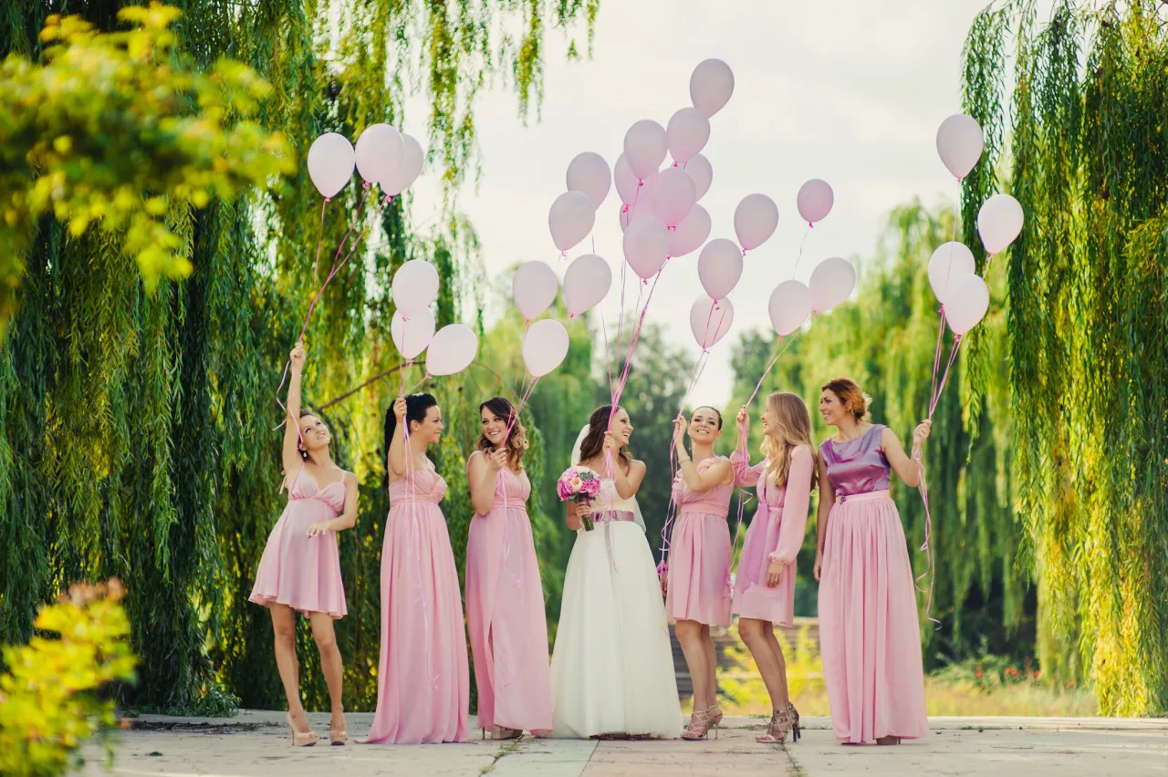 bridal party in pink dresses with balloons