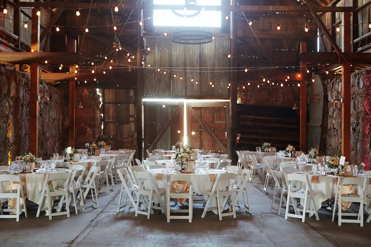 barn wedding venue with white chairs