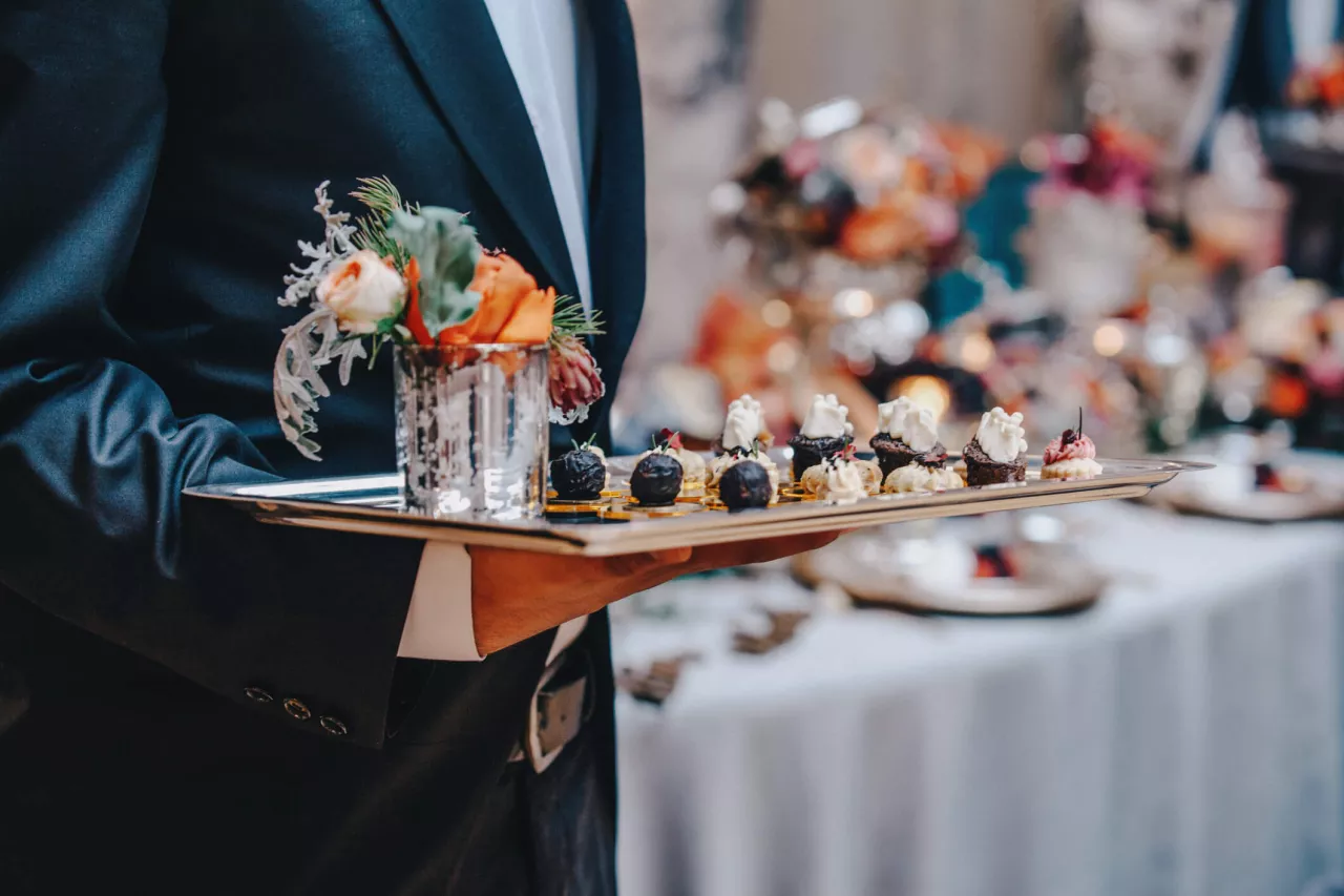 caterer serving hors d'oeuvres at a wedding