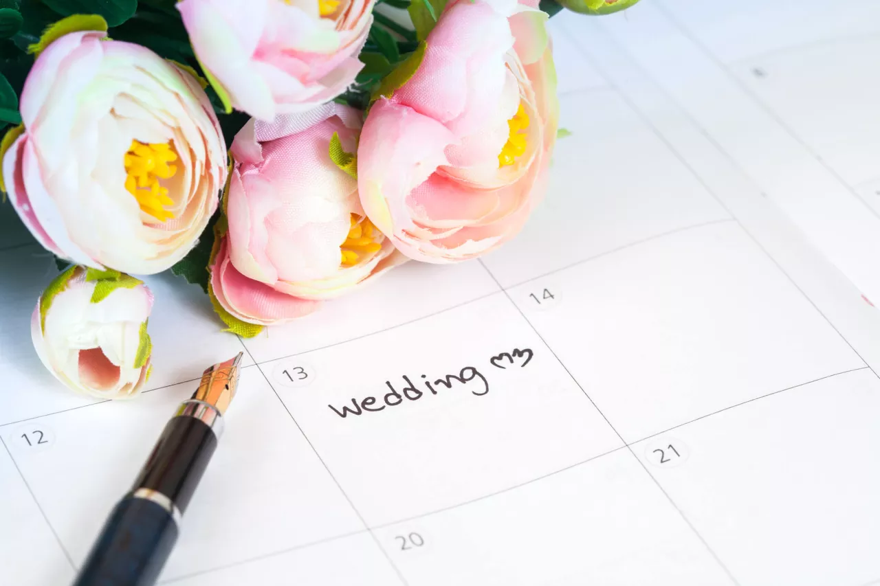 wedding flowers sitting on calendar for wedding day