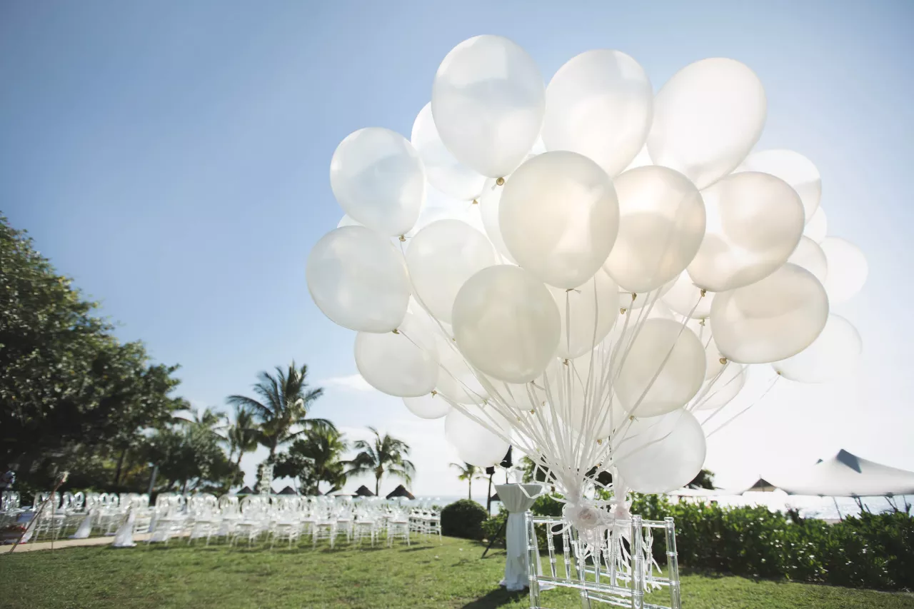 white balloons set up outside for morning wedding 